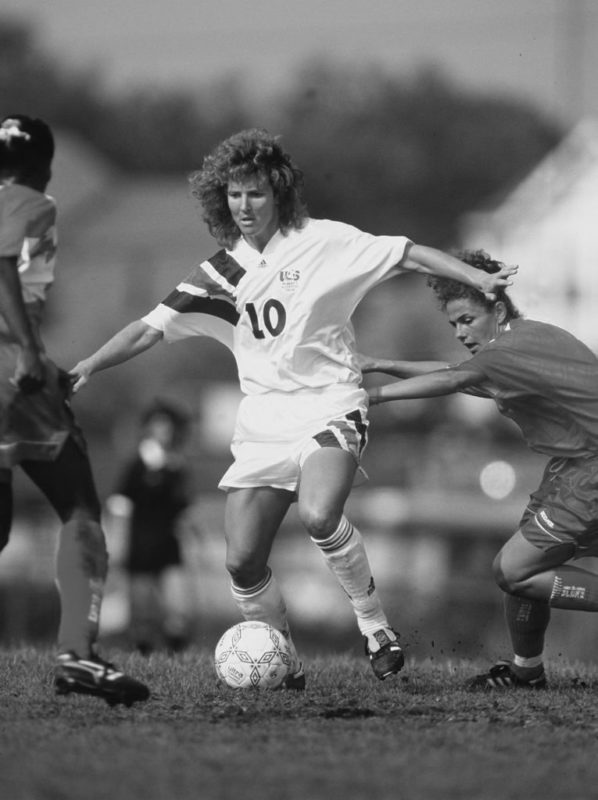 Michelle Akers-Stahl plays soccer for Team USA in a game against Canada.
