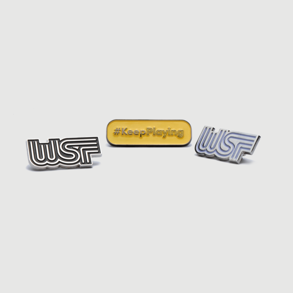 WSF pins in silver and white and #KeepPlaying pin in yellow