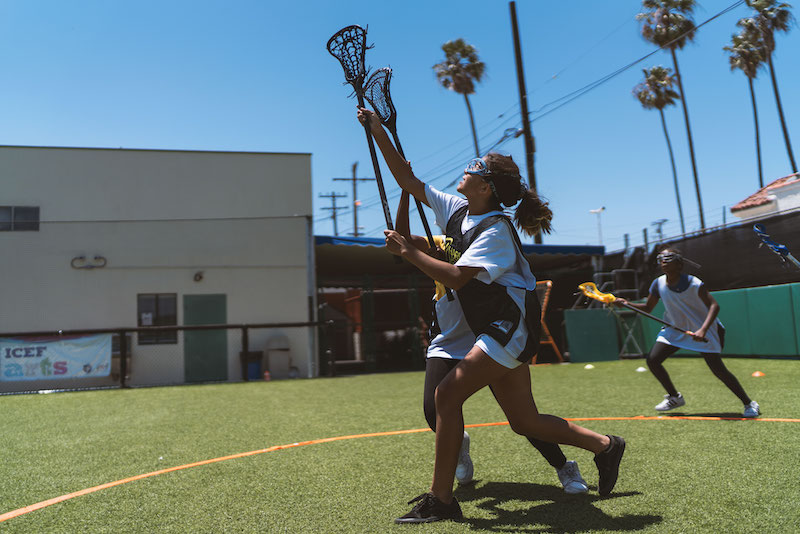 Young girls playing lacrosse