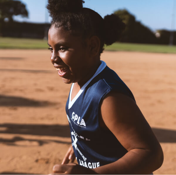 Young girl playing softball