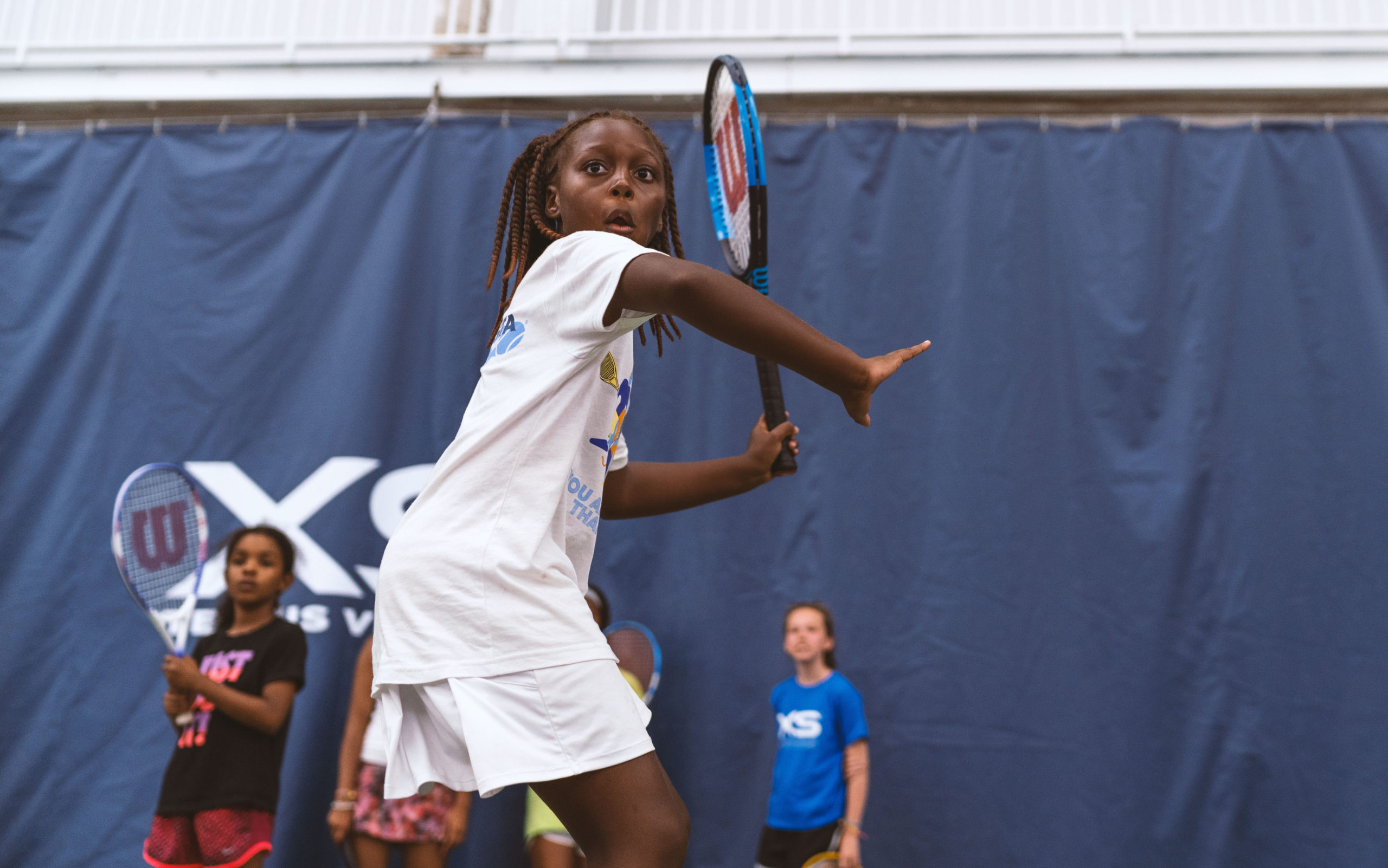 Young girls playing tennis