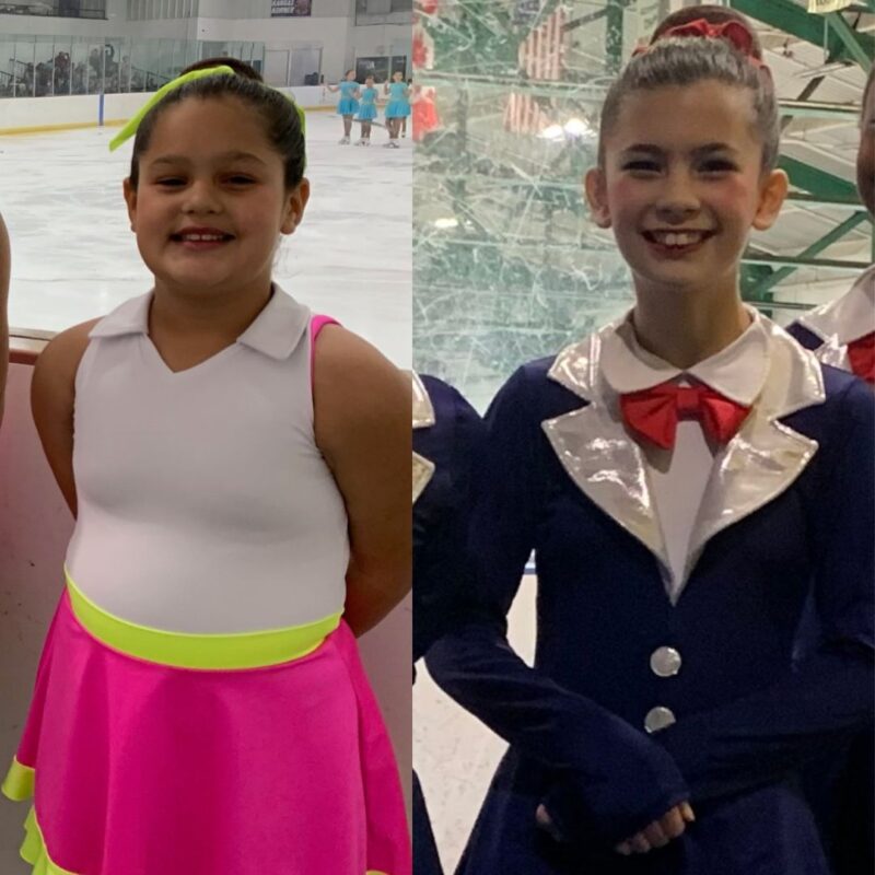 A young girl on the left with a white, yellow and pink dress. A young girl on the right in a shiny black and white coat and a red bowtie.
